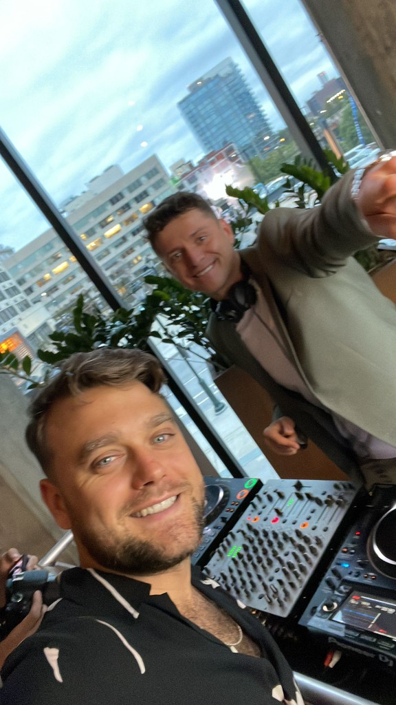 Adrian G with another DJ beside a rooftop setup