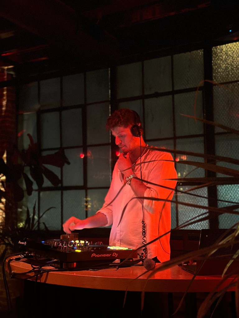 Adrian G mixing under red light by a window